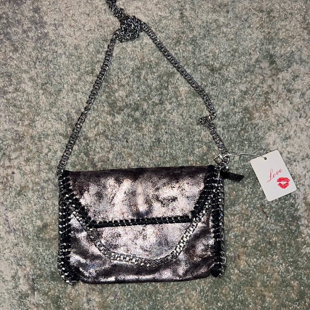 Trendy black and silver shoulder bag with chain detail.